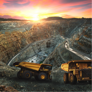 Construction trucks in a rocky terrain.