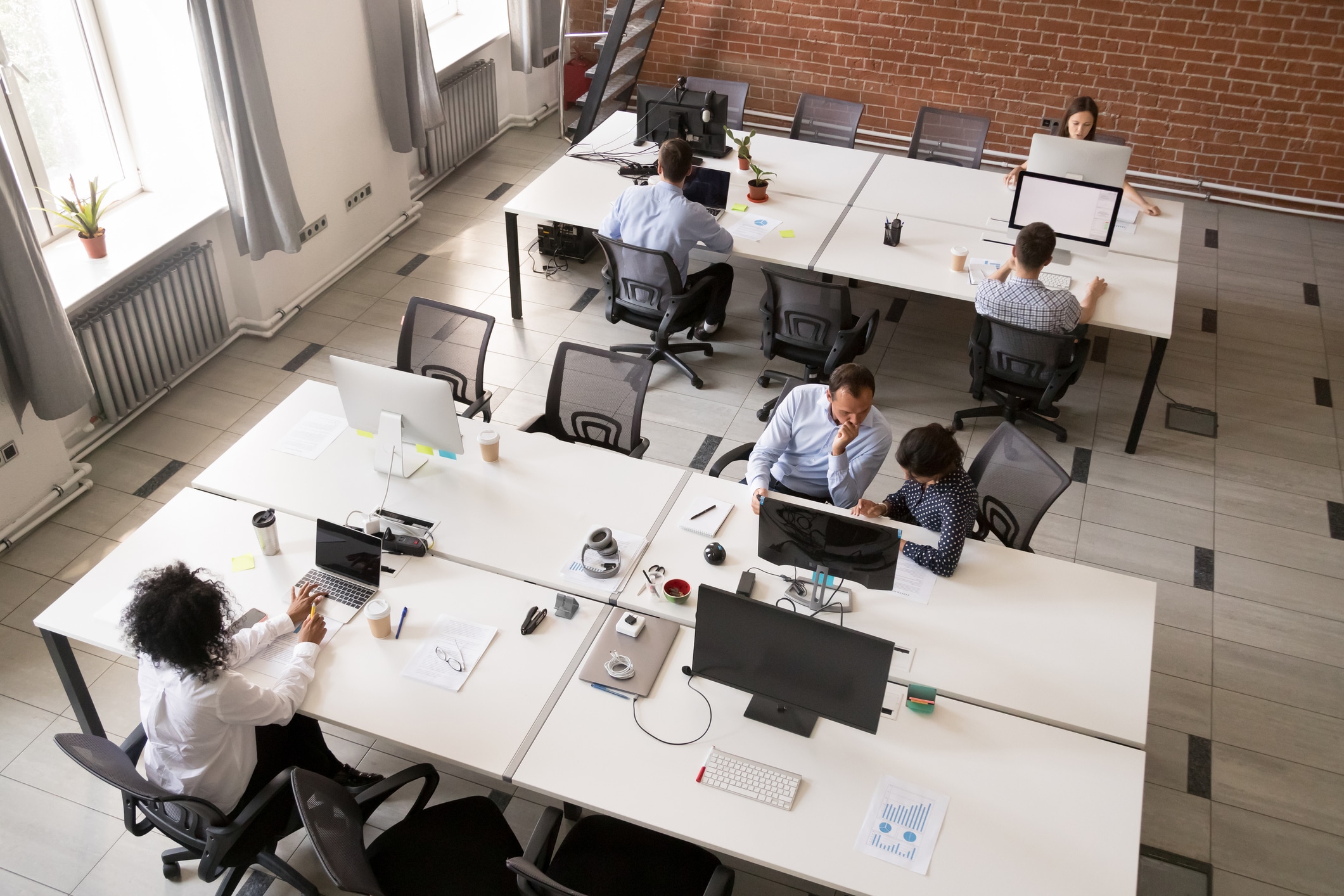 Birdseye view of an office with desk and employees