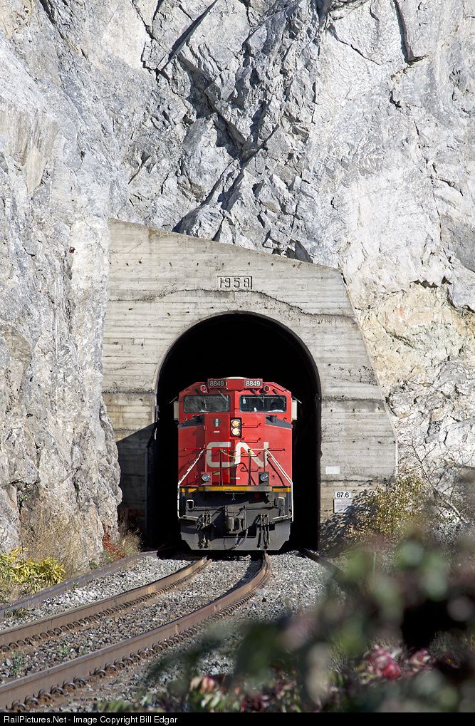 CN & CP Rail Tunnel with train going through the tunnel.