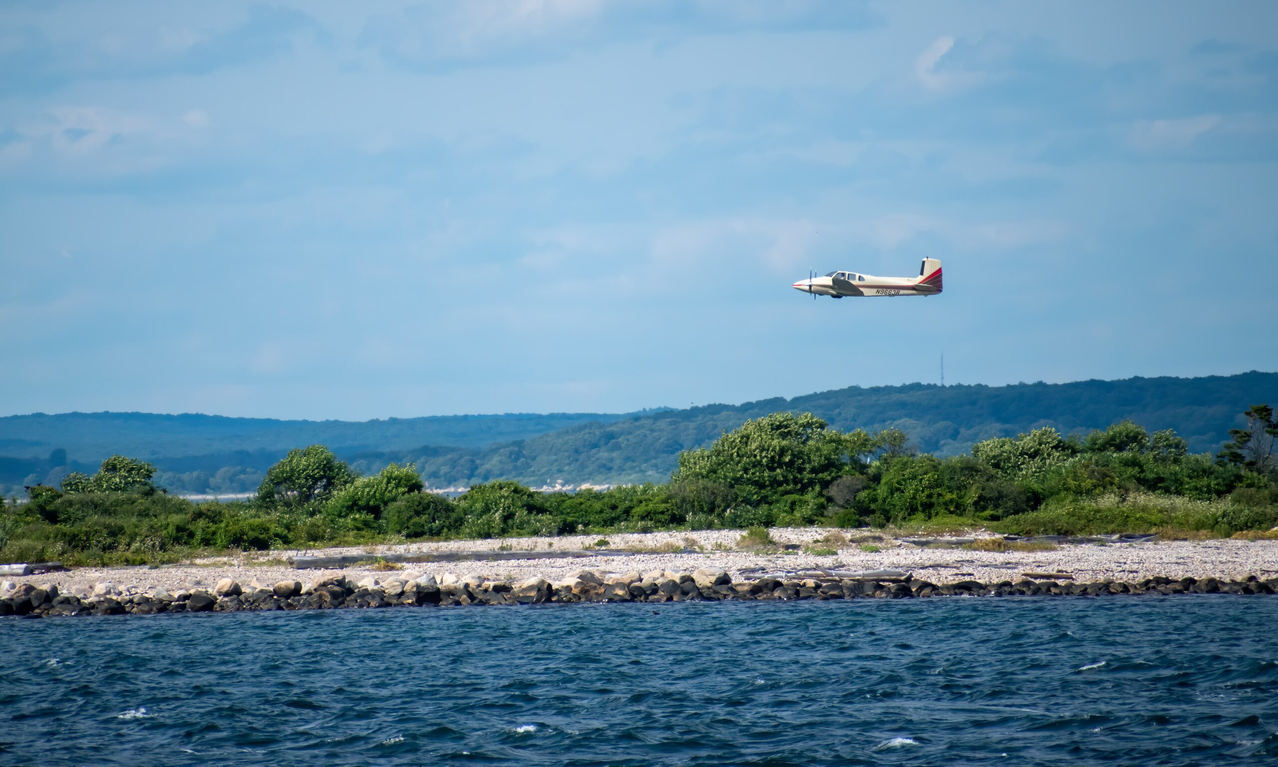 Body of water with plane about to land