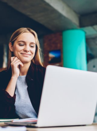 Woman smiling looking at laptop computer